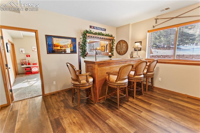 bar with wood-type flooring