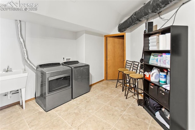 laundry area with tile patterned flooring, sink, and independent washer and dryer