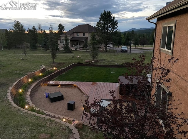 view of yard with a deck with mountain view