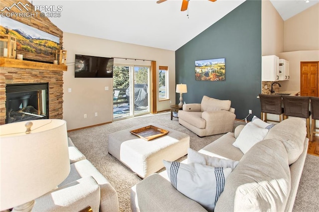 carpeted living room featuring ceiling fan, high vaulted ceiling, and a fireplace