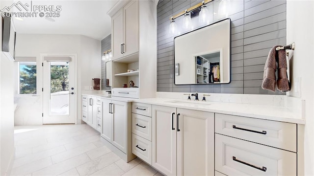 bathroom featuring vanity and backsplash