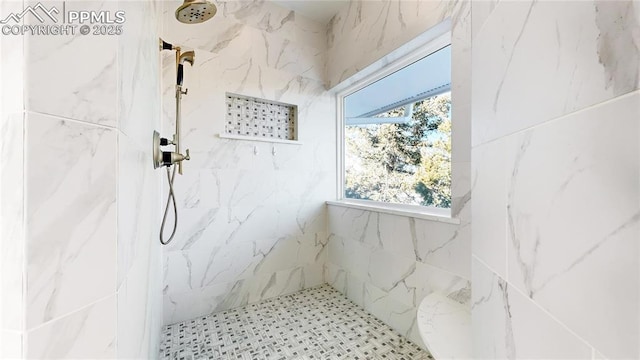 bathroom with a tile shower