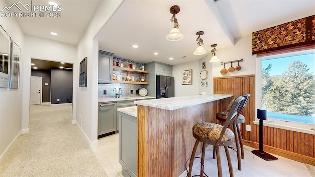 bar with gray cabinets, dishwasher, light stone counters, black fridge with ice dispenser, and decorative light fixtures