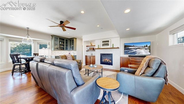 living room featuring hardwood / wood-style flooring and ceiling fan