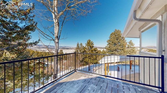 wooden terrace featuring a swimming pool