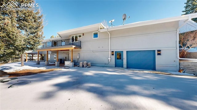 view of front of home featuring a balcony and a garage