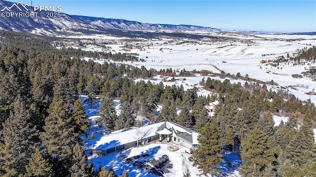 snowy aerial view with a mountain view