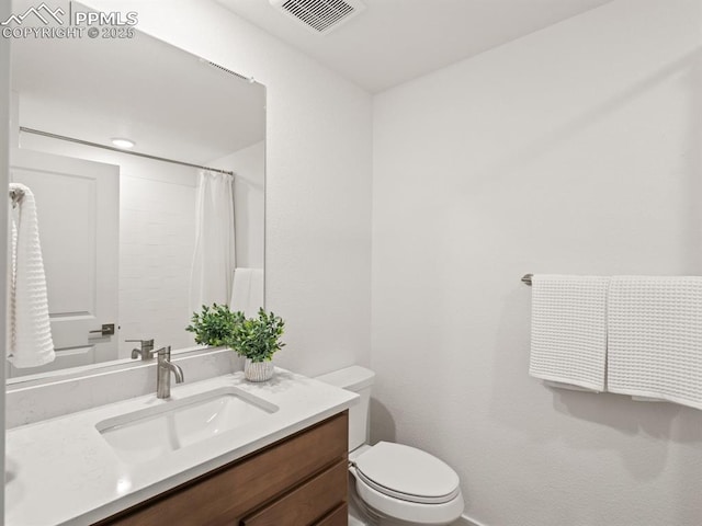 bathroom with vanity, a shower with curtain, and toilet