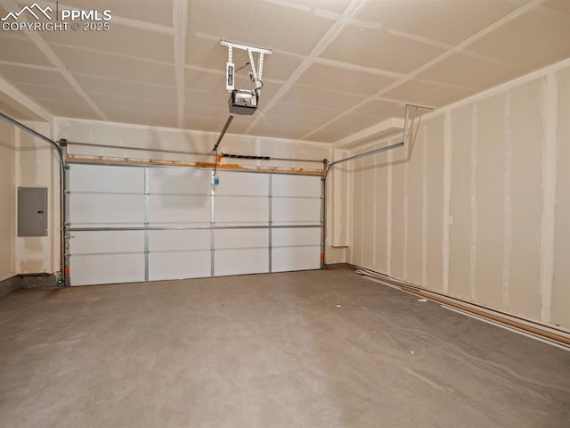 garage with a garage door opener and electric panel