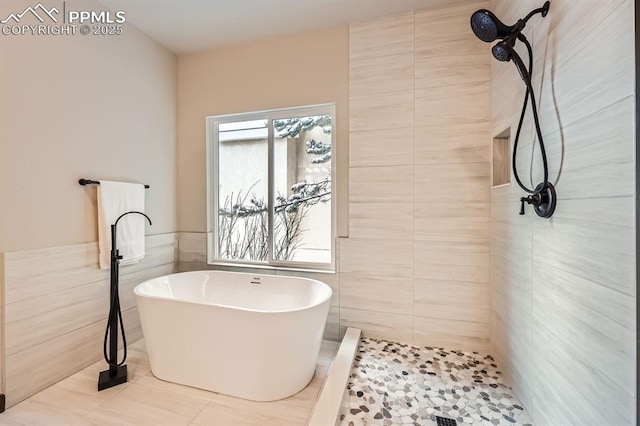 bathroom featuring tile patterned floors, independent shower and bath, and tile walls