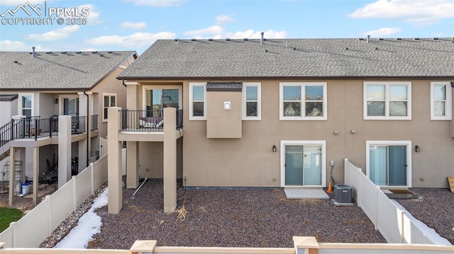 rear view of house featuring central AC and a balcony