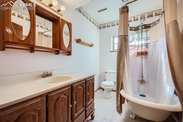 bathroom with vanity, tile patterned flooring, and toilet