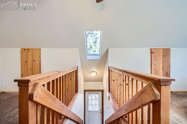 stairway with lofted ceiling and carpet floors