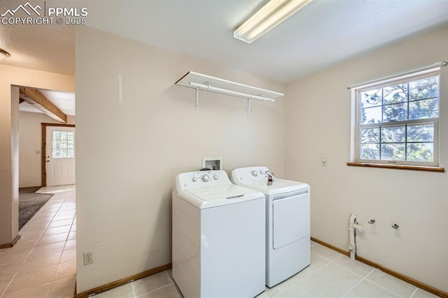 washroom featuring washer and dryer and light tile patterned floors