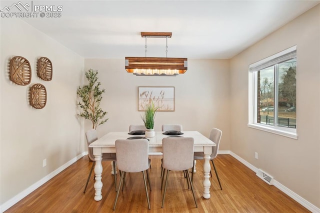 dining area featuring wood-type flooring