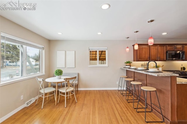 dining room with sink and light hardwood / wood-style floors