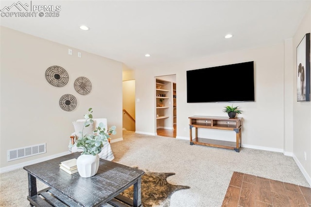 living room featuring carpet and built in features