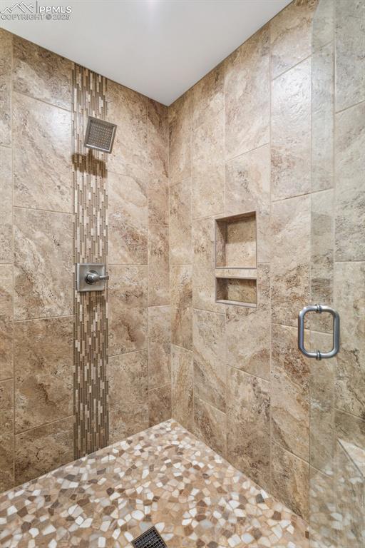 bathroom with a shower with door