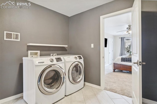 laundry area featuring ceiling fan, light tile patterned floors, and washer and clothes dryer