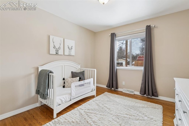 bedroom featuring wood-type flooring