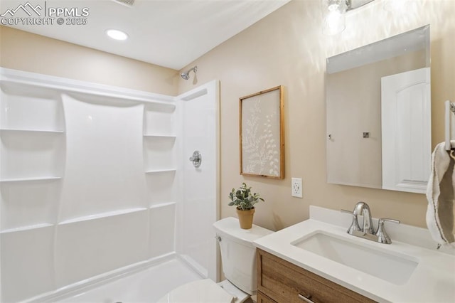 bathroom with vanity, toilet, and walk in shower