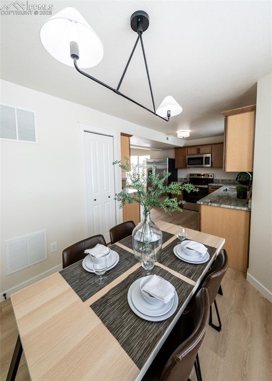 dining space featuring light hardwood / wood-style flooring