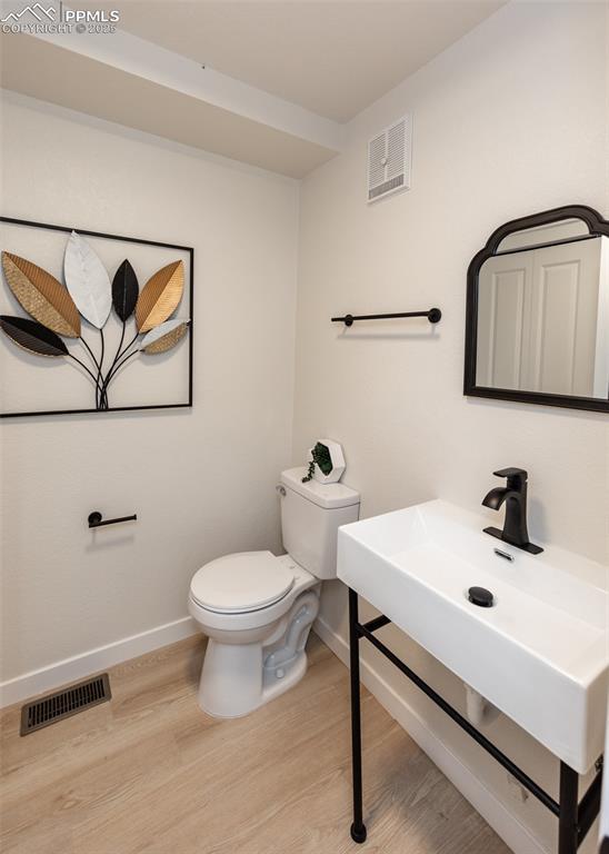 bathroom featuring toilet and hardwood / wood-style floors