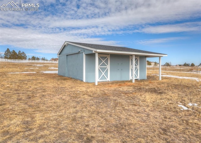 view of outbuilding with a rural view