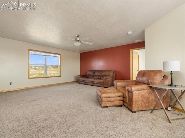 carpeted living room featuring ceiling fan and a textured ceiling