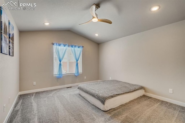 carpeted bedroom with ceiling fan and lofted ceiling