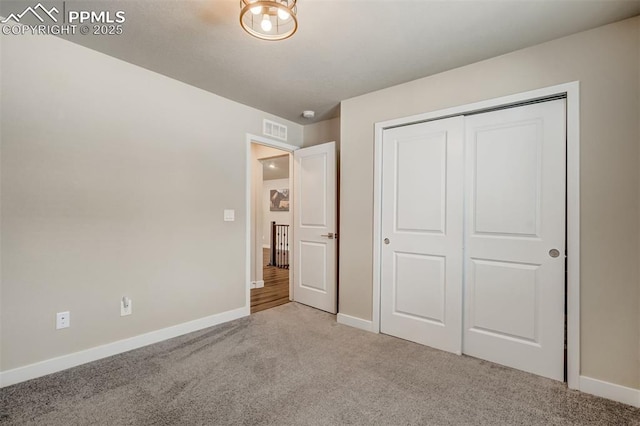 unfurnished bedroom featuring carpet floors and a closet