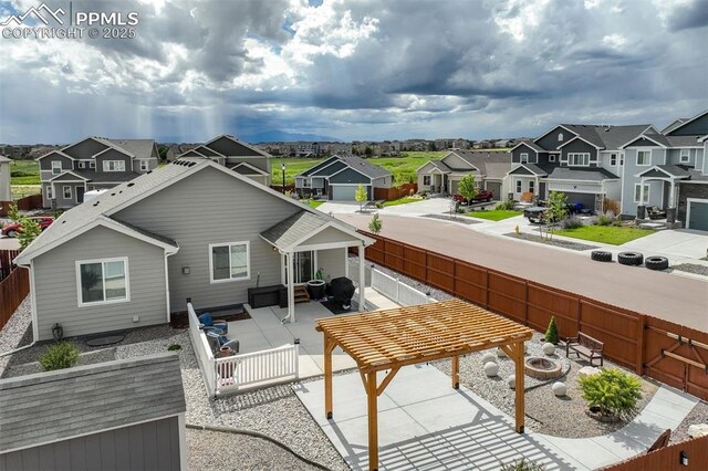 back of property featuring a pergola, a patio area, and a fire pit