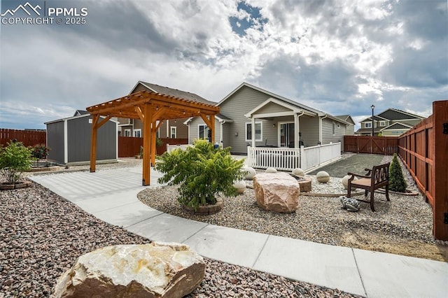 view of front of house featuring a pergola and a storage shed