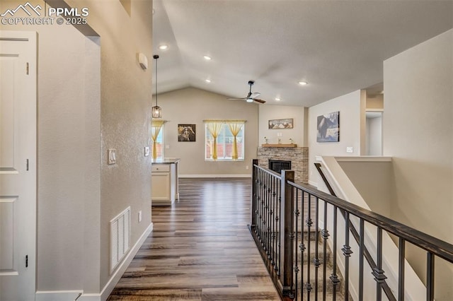 hallway with lofted ceiling and dark hardwood / wood-style flooring