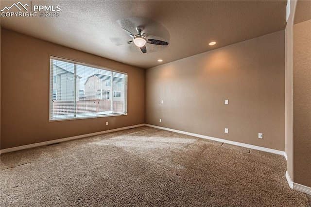 carpeted spare room with ceiling fan and a textured ceiling