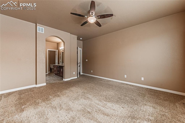 unfurnished room featuring a textured ceiling, carpet floors, and ceiling fan