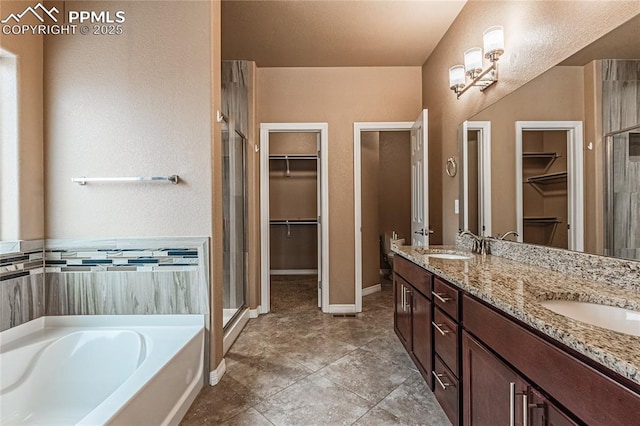 bathroom featuring vanity, shower with separate bathtub, and tile patterned flooring