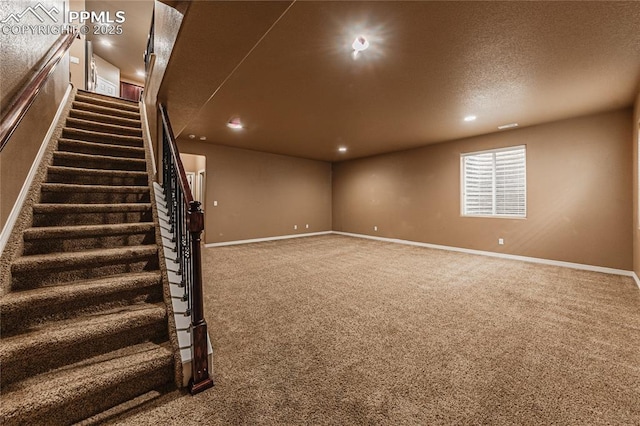 basement with carpet floors and a textured ceiling