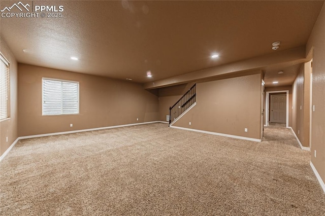 basement featuring carpet floors and a textured ceiling