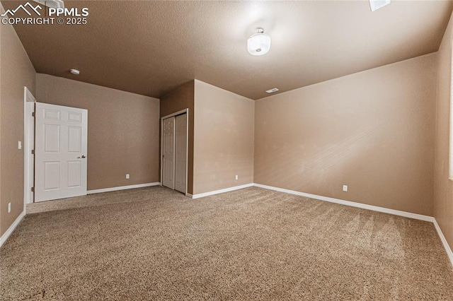 unfurnished bedroom with a closet, a textured ceiling, and carpet