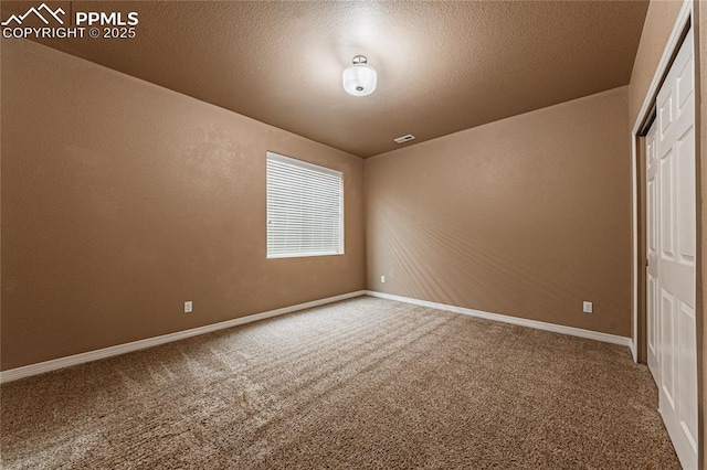 unfurnished bedroom featuring carpet floors, a closet, and a textured ceiling