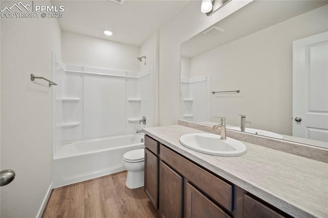 full bathroom with wood-type flooring, toilet, tub / shower combination, and vanity