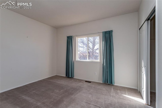 unfurnished bedroom with a closet and carpet flooring