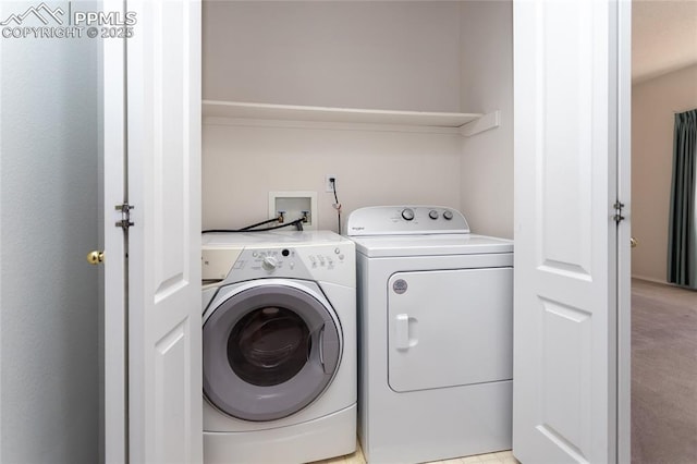 laundry area featuring separate washer and dryer and light colored carpet