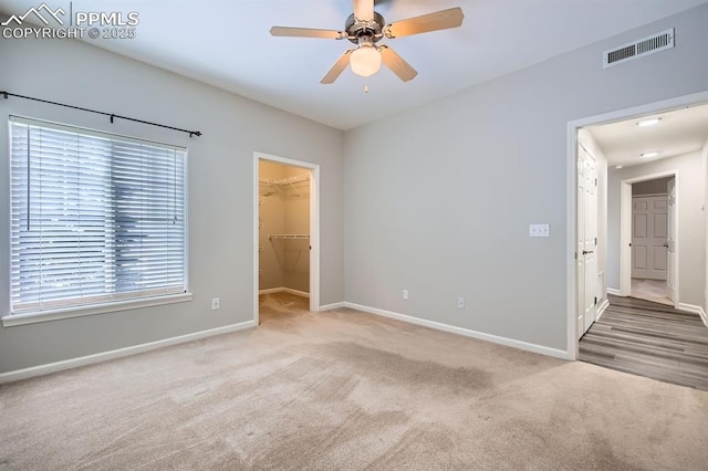 carpeted empty room with ceiling fan