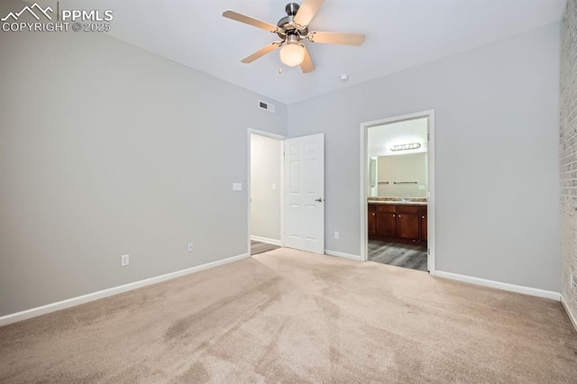 unfurnished bedroom with sink, ensuite bath, ceiling fan, and carpet flooring