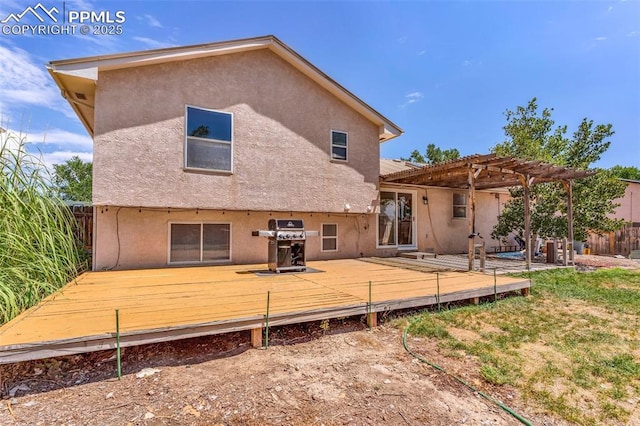 back of property with a wooden deck and a pergola