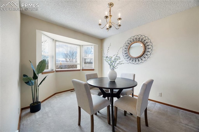 dining area with light carpet, a textured ceiling, baseboards, and an inviting chandelier