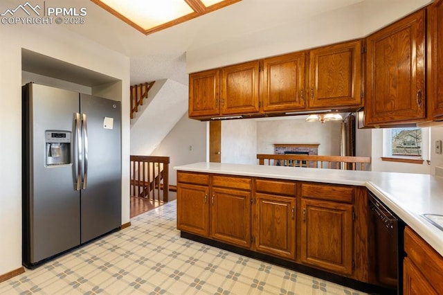 kitchen with black dishwasher, light countertops, brown cabinetry, and stainless steel fridge with ice dispenser