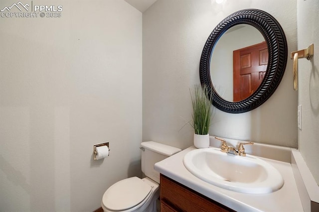 half bathroom with toilet and vanity